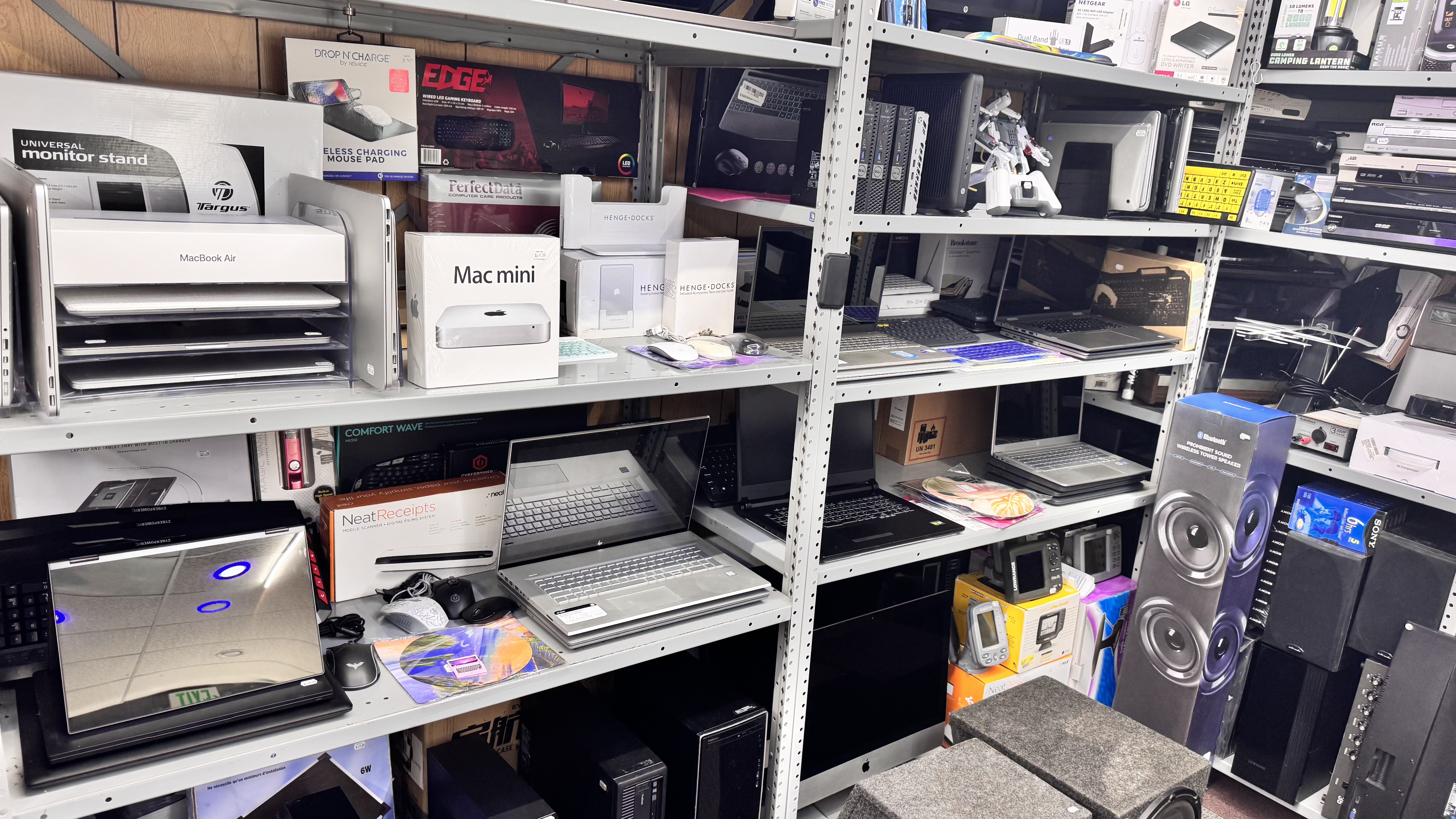 Laptops and Mac mini on shelves
